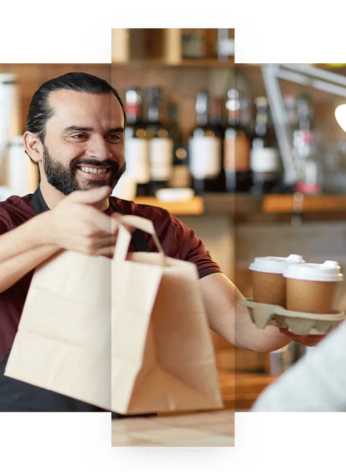 Coffee owner handing a customer coffee and takeout