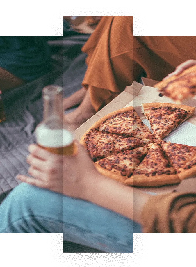 Woman enjoying takeout pizza and beer with friends